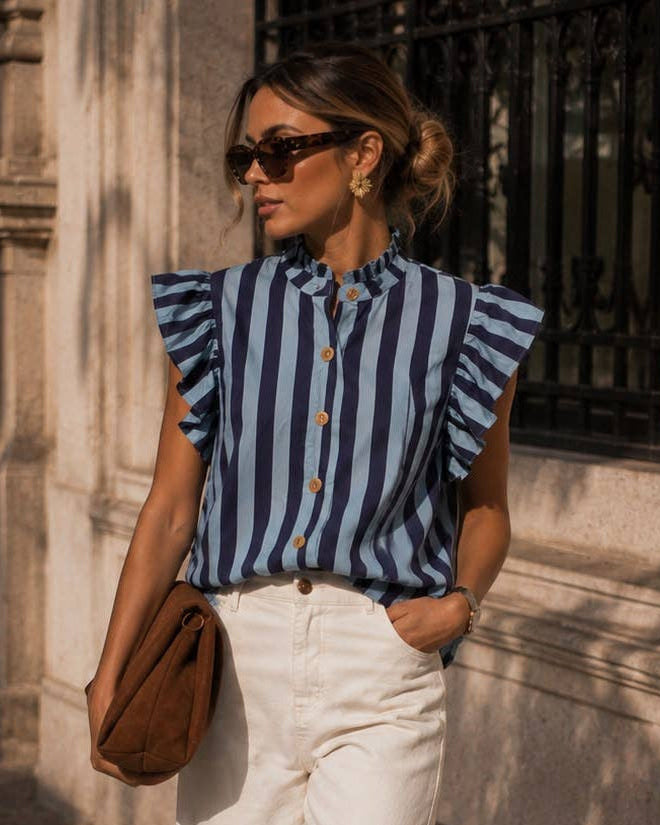 Woman wearing a Calla Lily Cosmetics + CL kids blue striped cotton shirt with ruffled shoulders and stand-up collar