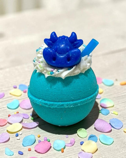 Calla Lily Cosmetics + CL kids teal bubbly ball bath bomb with a blue cow topper and bath crayon on white wood