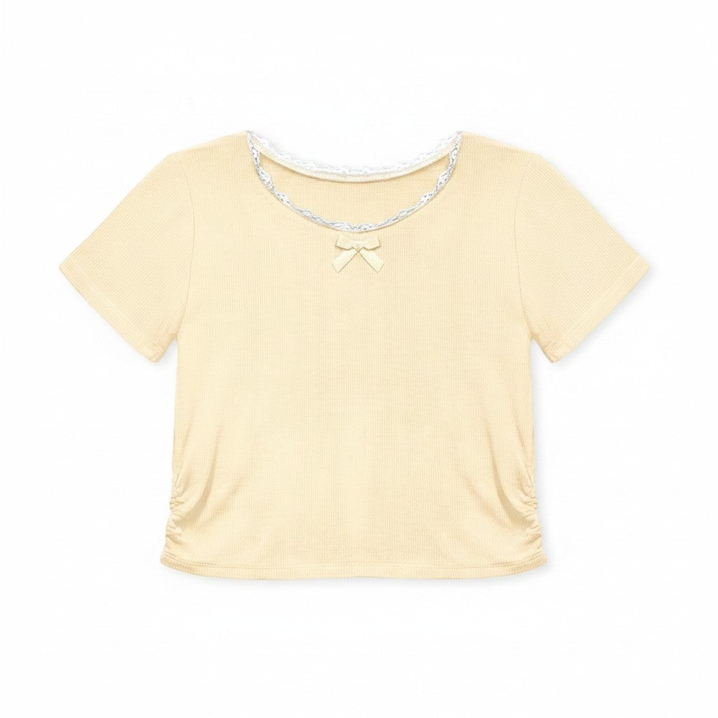Calla Lily Cosmetics + CL kids toddler yellow ribbed knit top with lace trim and bow, paired with blue chambray shorts.