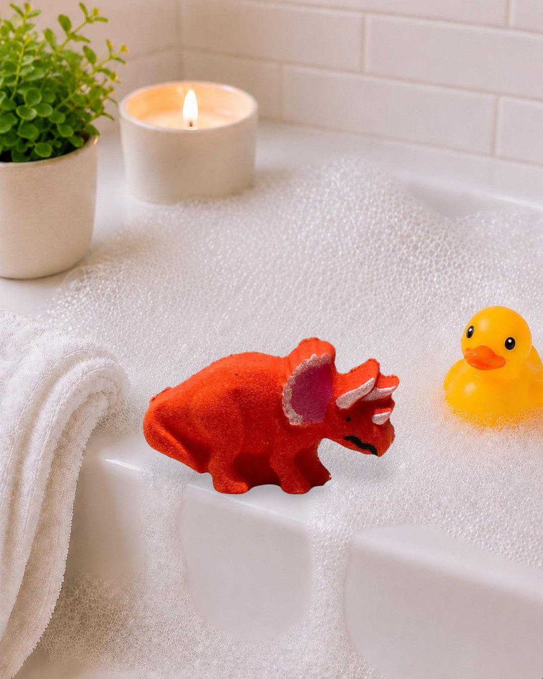 Calla Lily Cosmetics + CL kids red orange triceratops dinosaur bath bomb with strawberry blood orange scent.