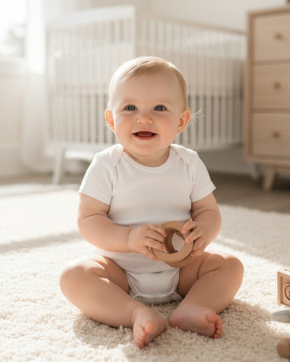 Calla Lily Cosmetics + CL kids white 100% cotton short-sleeve baby bodysuit with lap shoulder neckline and snap closure.