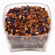 A clear square plastic container filled with loose-leaf herbal tea blend, featuring dried flowers and botanical pieces in orange, brown, purple, and red tones, shown against a plain white background.