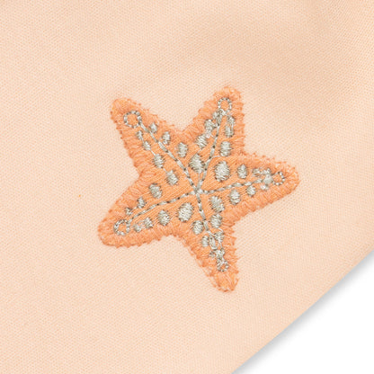 Starfish-shaped patch with decorative elements on a beige background