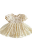 Beige baby dress with floral embroidery on a white background