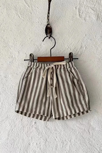 Striped shorts hanging on a hook against a white wall
