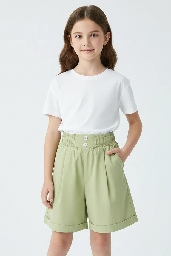 Light green shorts on a white background with a book and glasses in the corner.