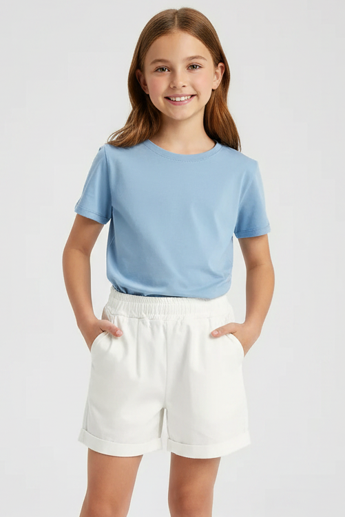 White shorts on a light gray background with a pair of sunglasses and a photo frame.