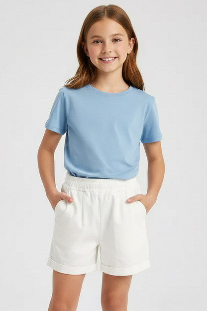 White shorts on a light gray background with a pair of sunglasses and a photo frame.
