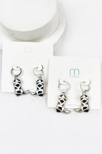 Cowboy boot earrings on a white card with a brand logo.