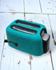 Calla Lily Cosmetics + CL kids teal toaster-shaped bath bomb with floral scent and skin-loving coconut oil