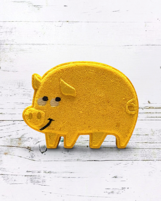 Calla Lily Cosmetics + CL kids yellow pig-shaped bath bomb with pineapple scent and nourishing cocoa butter.