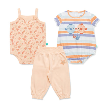 Set of baby clothing including a onesie, tank top, and pants on a white background