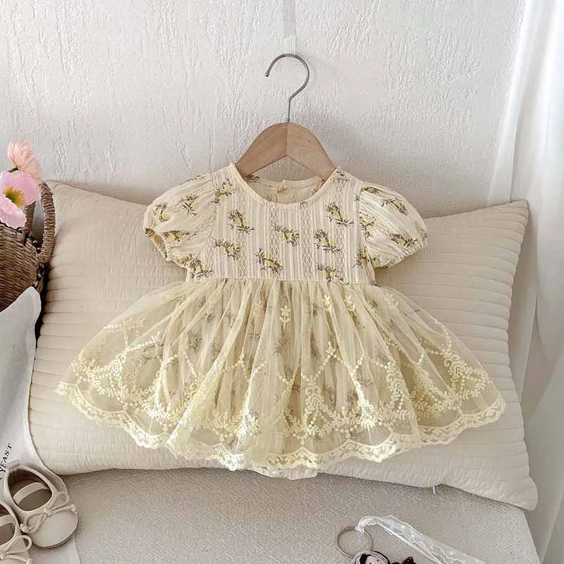 Delicate lace dress on a hanger against a neutral background