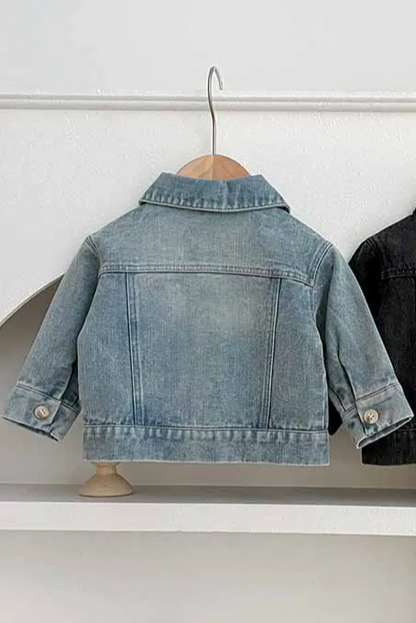 Two denim jackets, one blue and one black, on hangers against a white background.