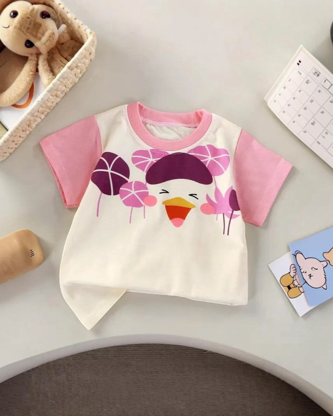 Children's t-shirt with cartoon design on a light surface