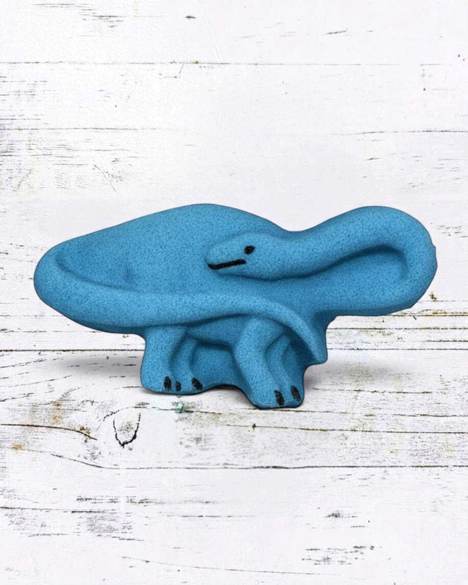 Calla Lily Cosmetics + CL kids blue brontosaurus shaped bath bomb with blueberry scent on a white wooden background