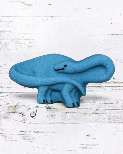 Calla Lily Cosmetics + CL kids blue brontosaurus shaped bath bomb with blueberry scent on a white wooden background