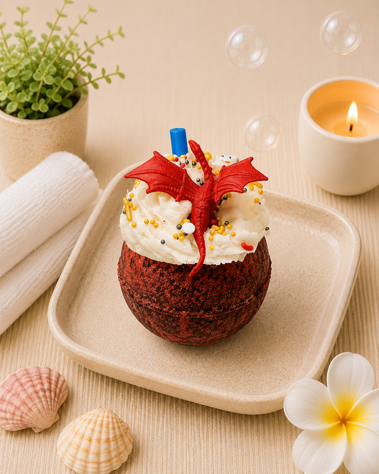 Red dragon-themed dessert on a beige plate with bubbles and a candle in the background