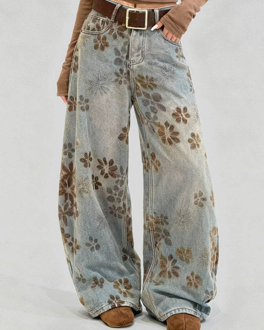 Floral-patterned wide-leg jeans worn by a person on a plain background