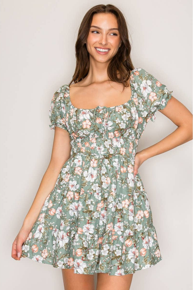 Woman wearing a floral dress against a plain background