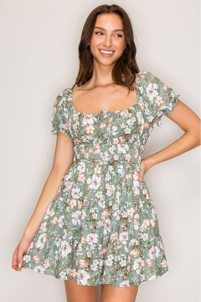 Woman wearing a floral dress against a plain background