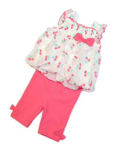 Baby outfit with floral top and pink pants on a white background