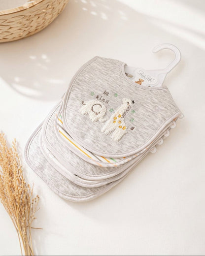 Stack of gray baby bibs with embroidered designs on a white surface