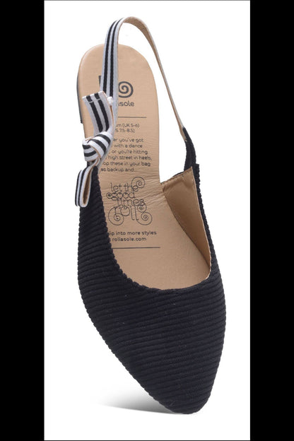 Black flat shoe with a striped ankle strap on a white background