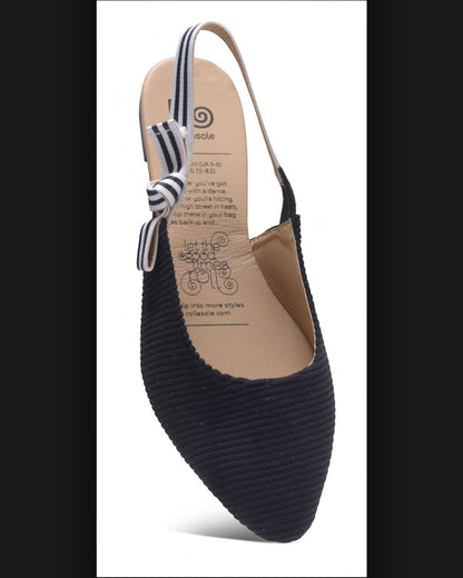 Black flat shoe with a striped ankle strap on a white background