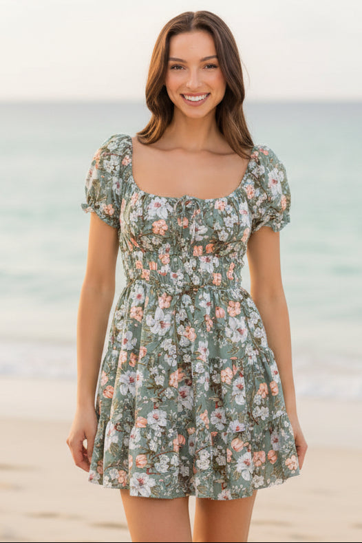 Woman wearing a floral dress against a plain background