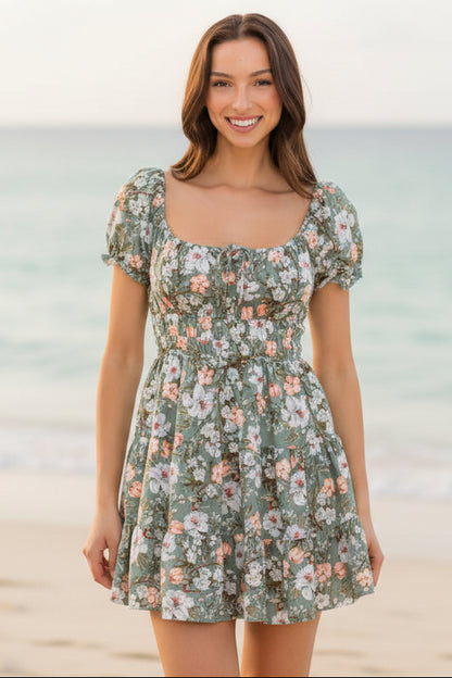 Woman wearing a floral dress against a plain background