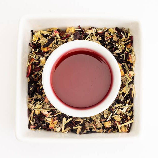 Tea leaves and a cup of tea on a white background