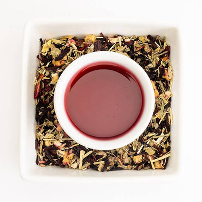 Tea leaves and a cup of tea on a white background