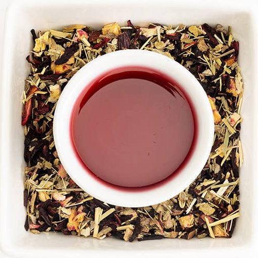 Tea leaves and a cup of tea on a white background