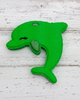Green dolphin-shaped object on a white background