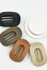 Set of five oval-shaped hair clips in black, brown, beige, and white on a light gray background.