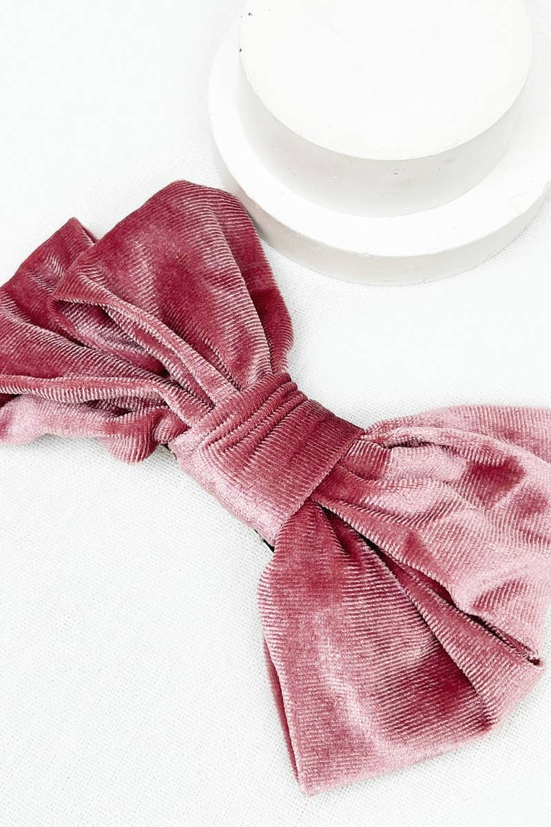 Pink velvet hair bow on a white background