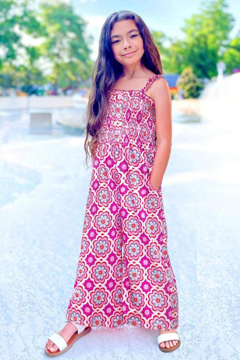 Young girl in a patterned dress standing outdoors