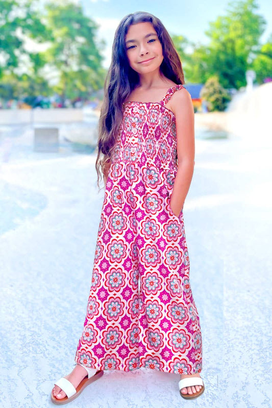 Young girl in a patterned dress standing outdoors