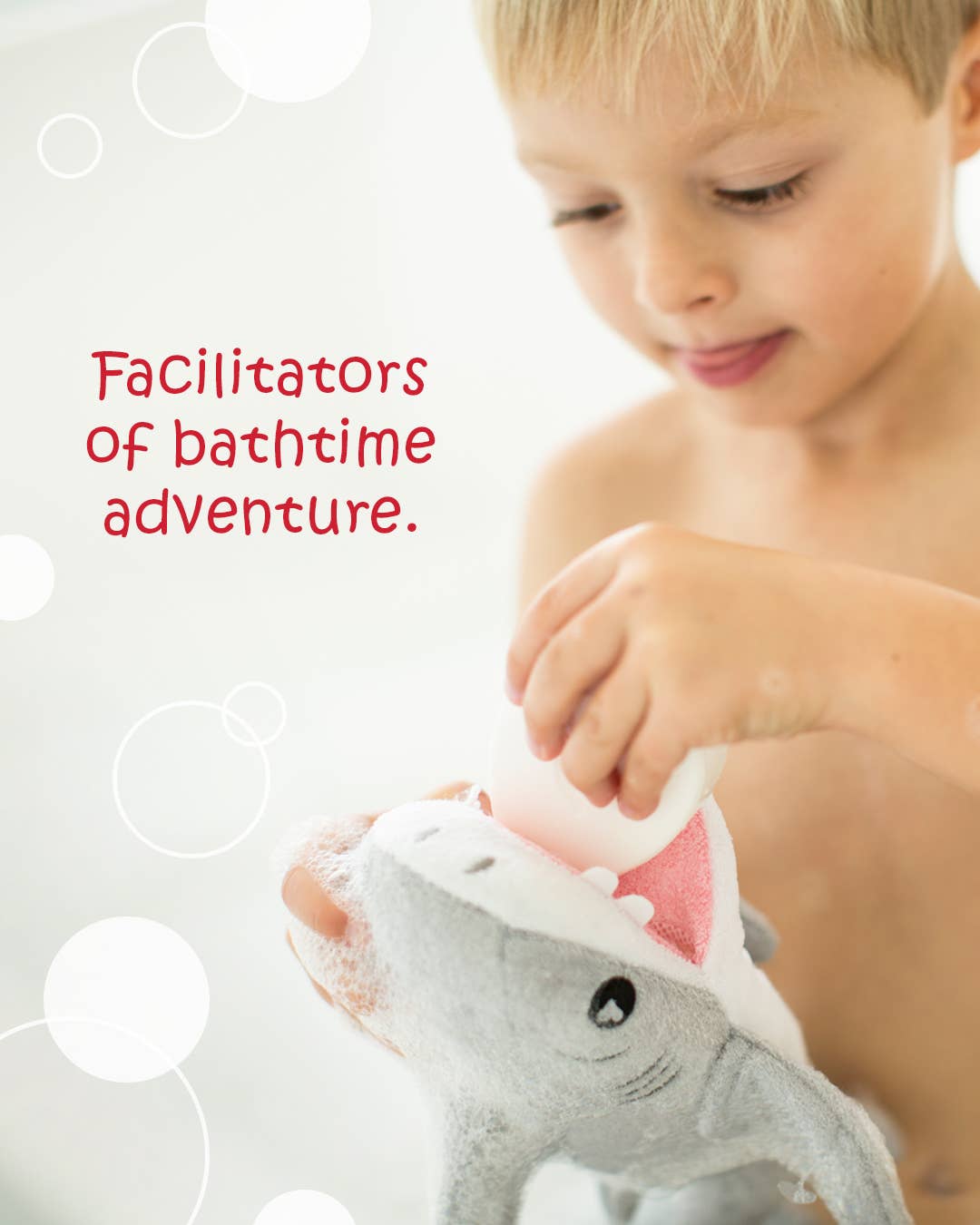 Child playing with a shark-shaped bath toy against a light background with text.