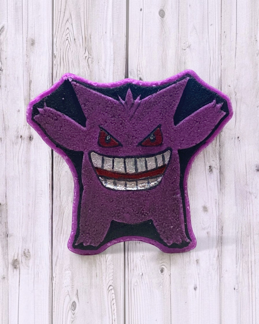 Calla Lily Cosmetics + CL kids Gengar shaped grape scented bath bomb with hand-painted purple and black mica details.