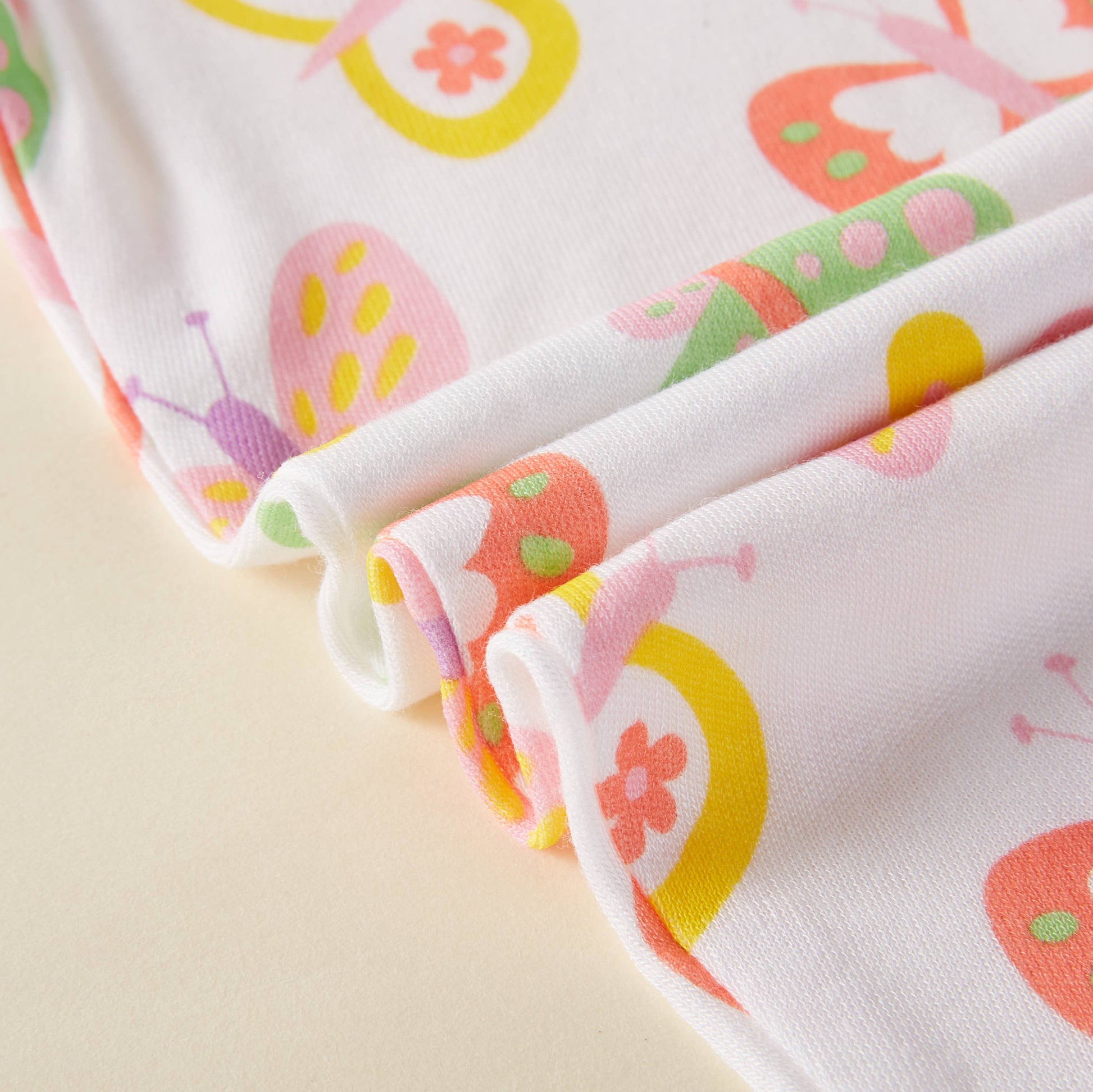 Close-up of colorful fabric with butterfly pattern on a beige background