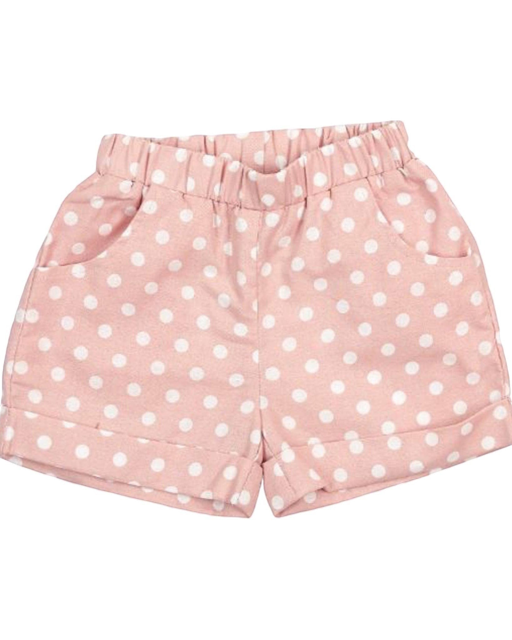 Pink shorts with white polka dots on a white background