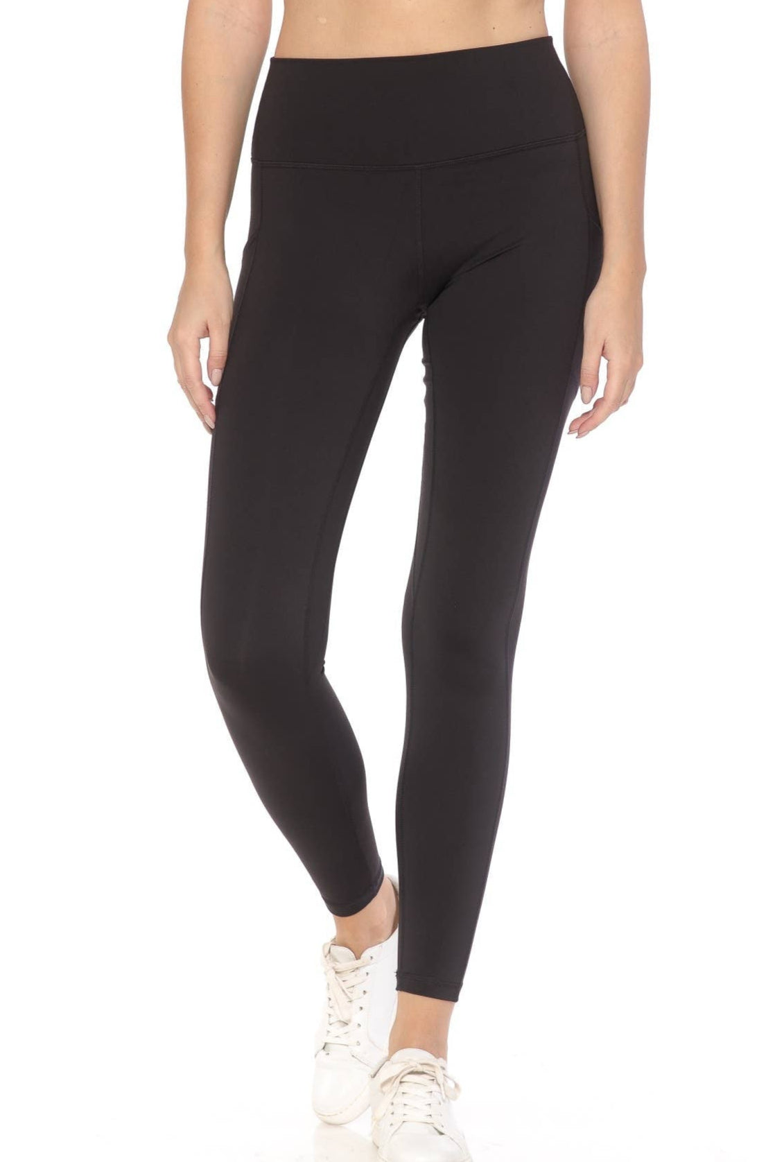 Person wearing black leggings on a white background