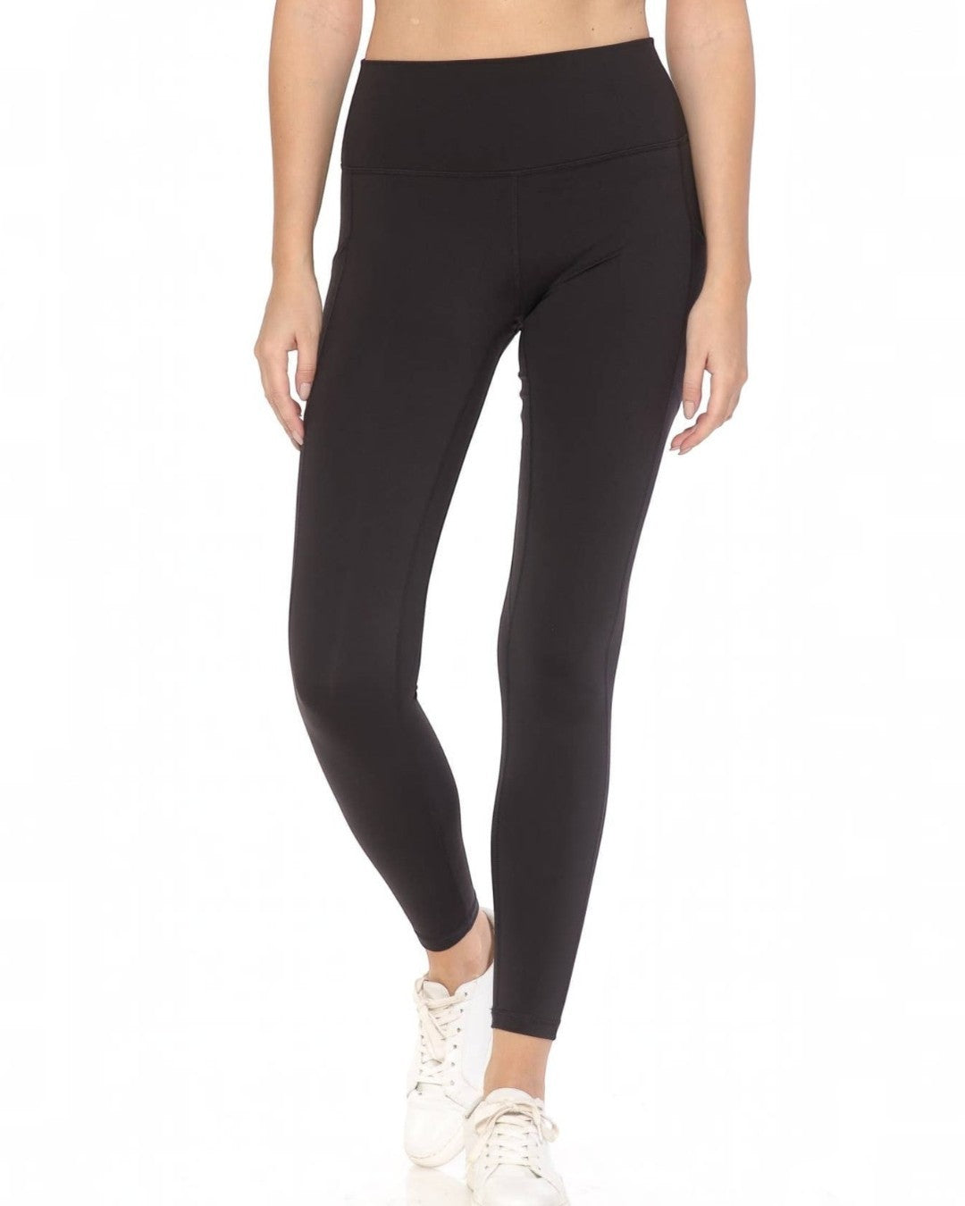 Person wearing black leggings on a white background