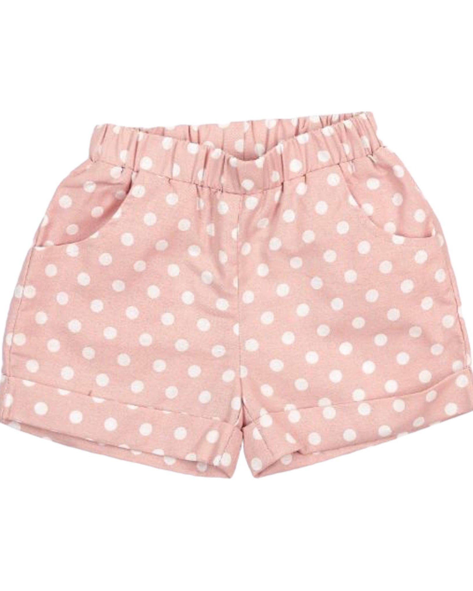 Pink shorts with white polka dots on a white background