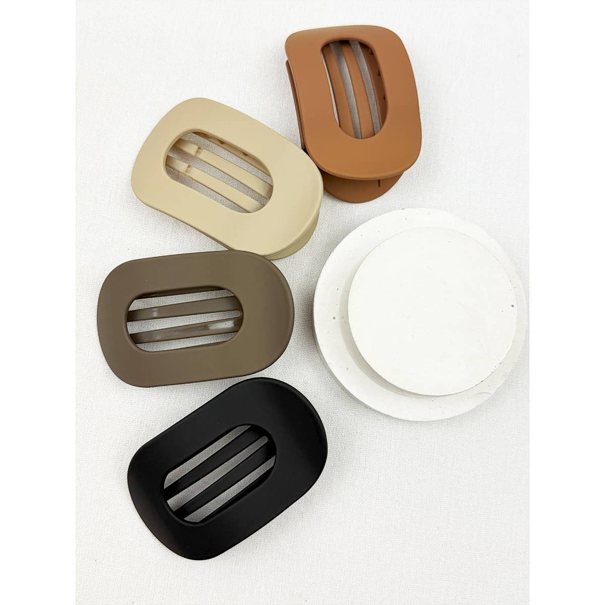Set of five rectangular plastic hair clips in different colors on a white background