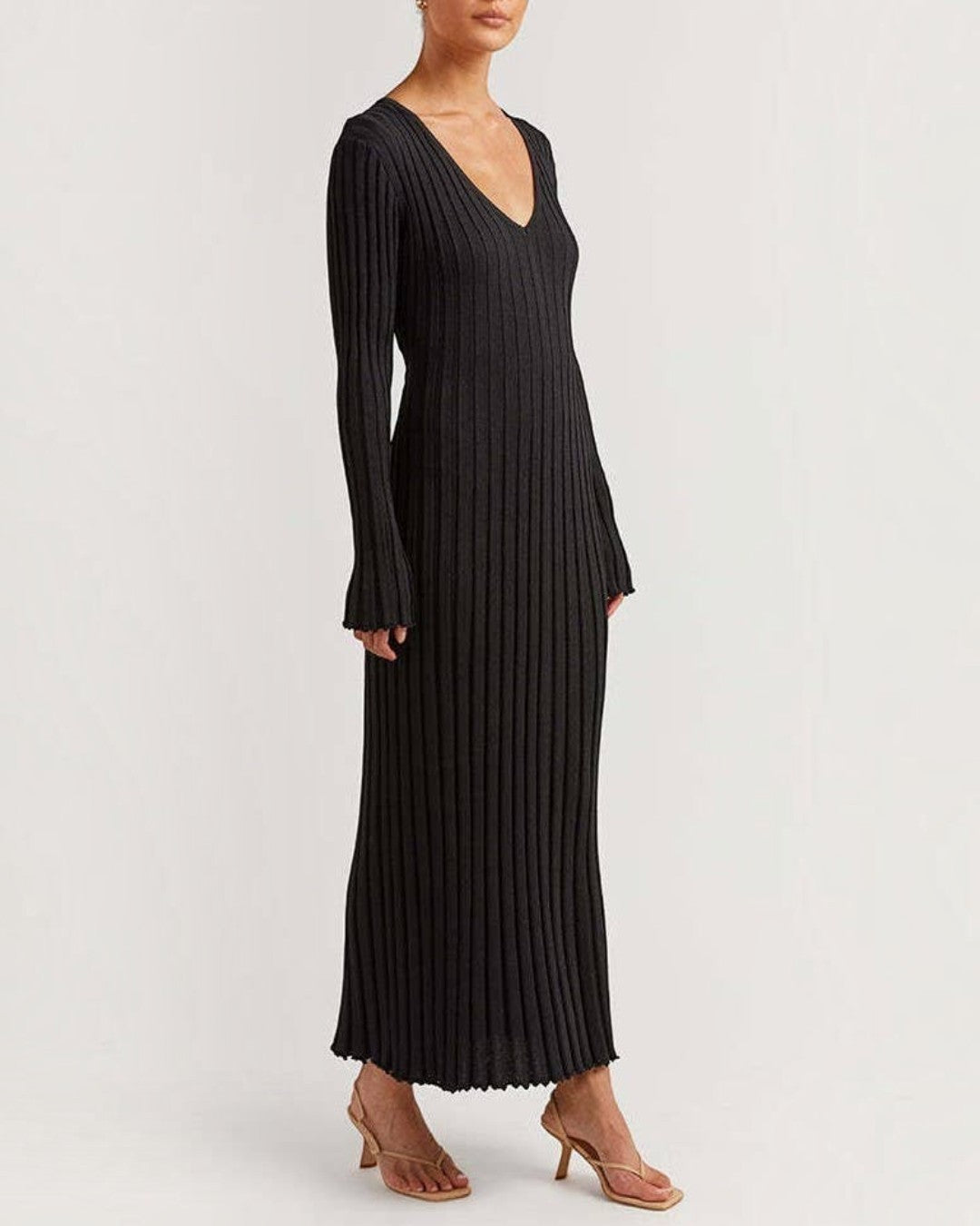Black ribbed dress worn by a model on a white background