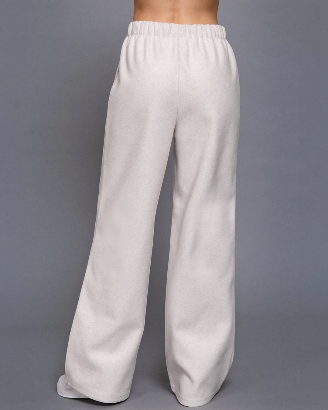 Light gray sweatpants on a gray background