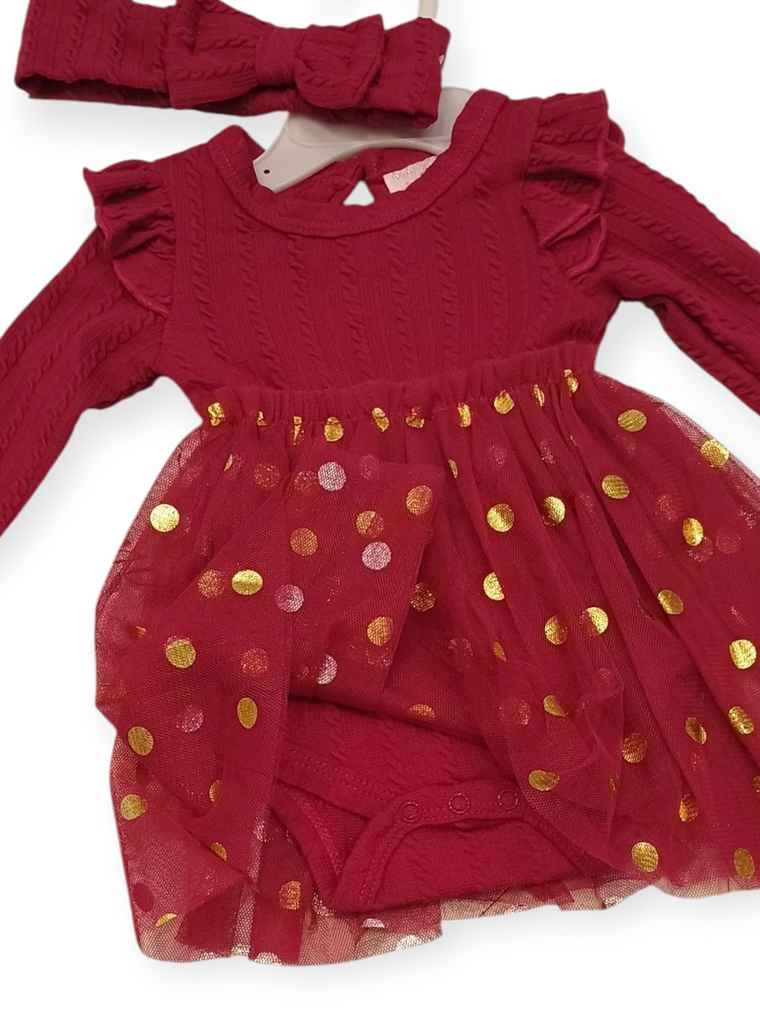 Red baby dress with gold polka dots and matching headband on a white background